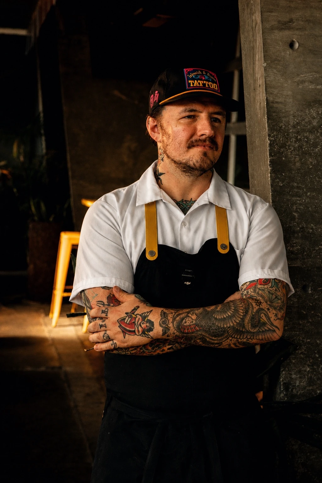 Chef Brendan Alvarez in his apron, standing in the kitchen