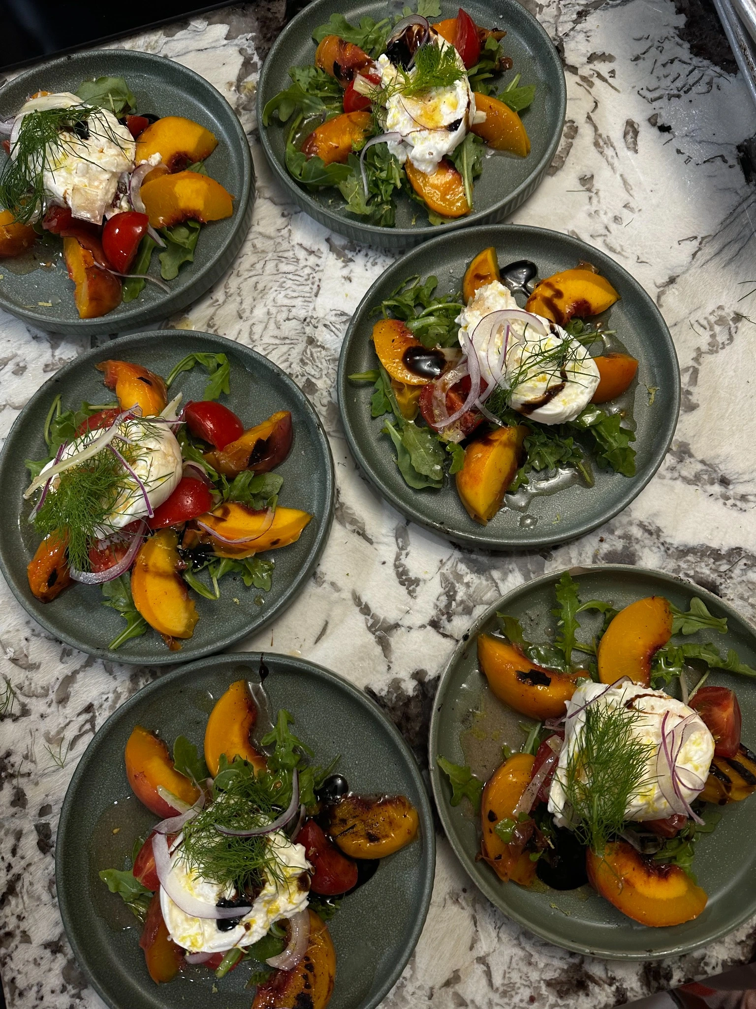 Colorful plated dishes with greens and roasted vegetables