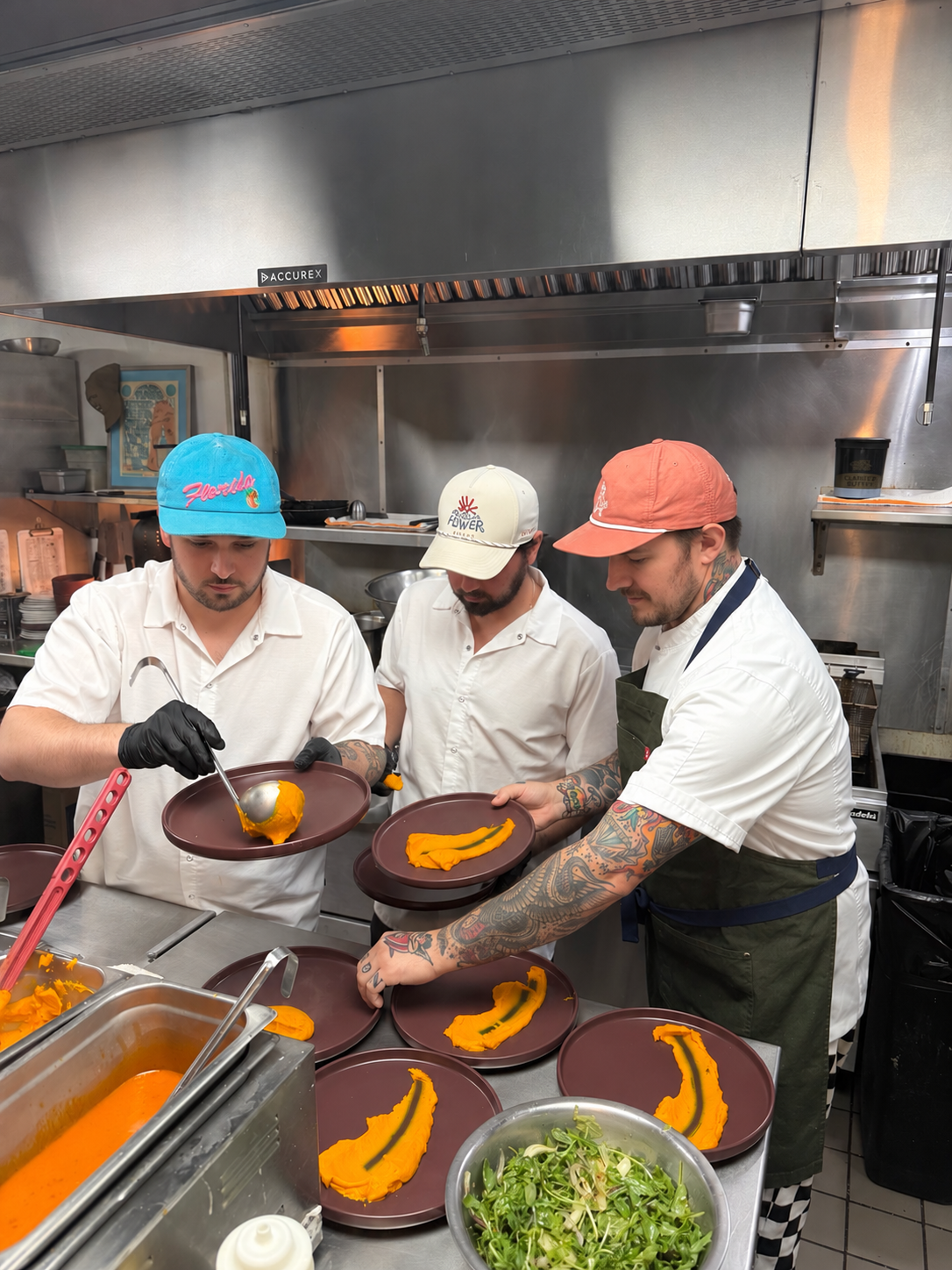 Chef Brendan and the kitchen team plating dishes during service