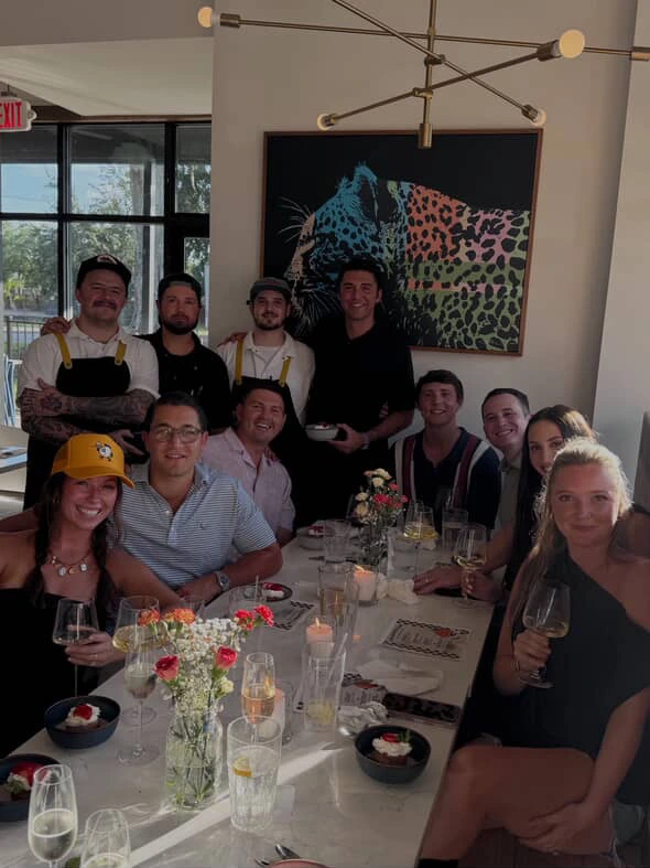 The Supper Club team and guests gathered around the dinner table